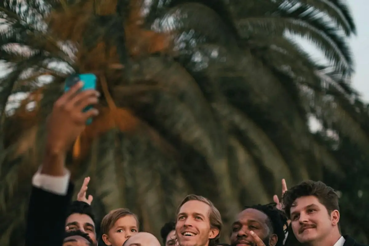 Wedding guests raising their phones to take photos