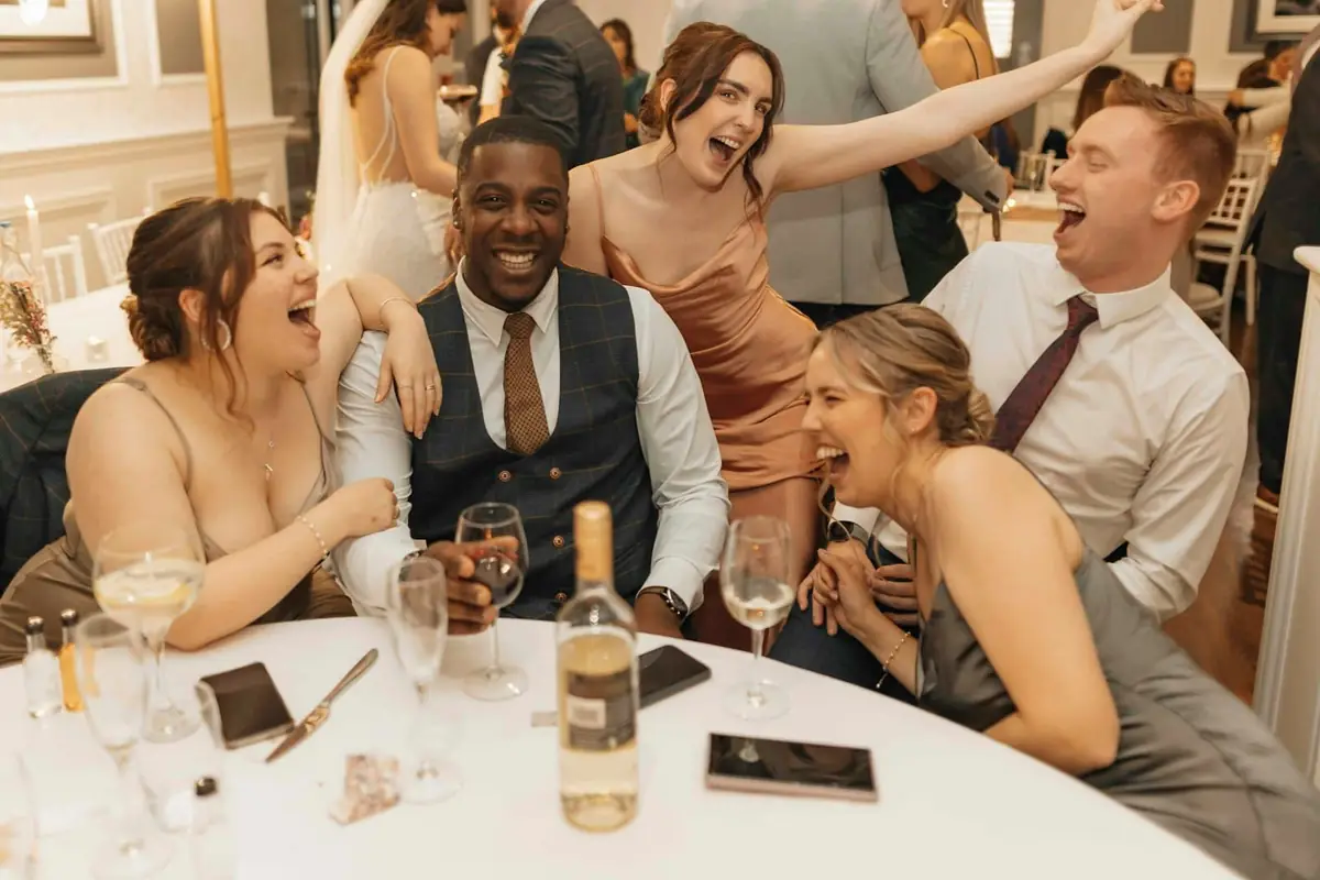Guests sitting around a table at a wedding