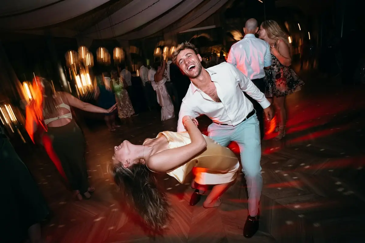 A couple dancing at a lively outdoor party