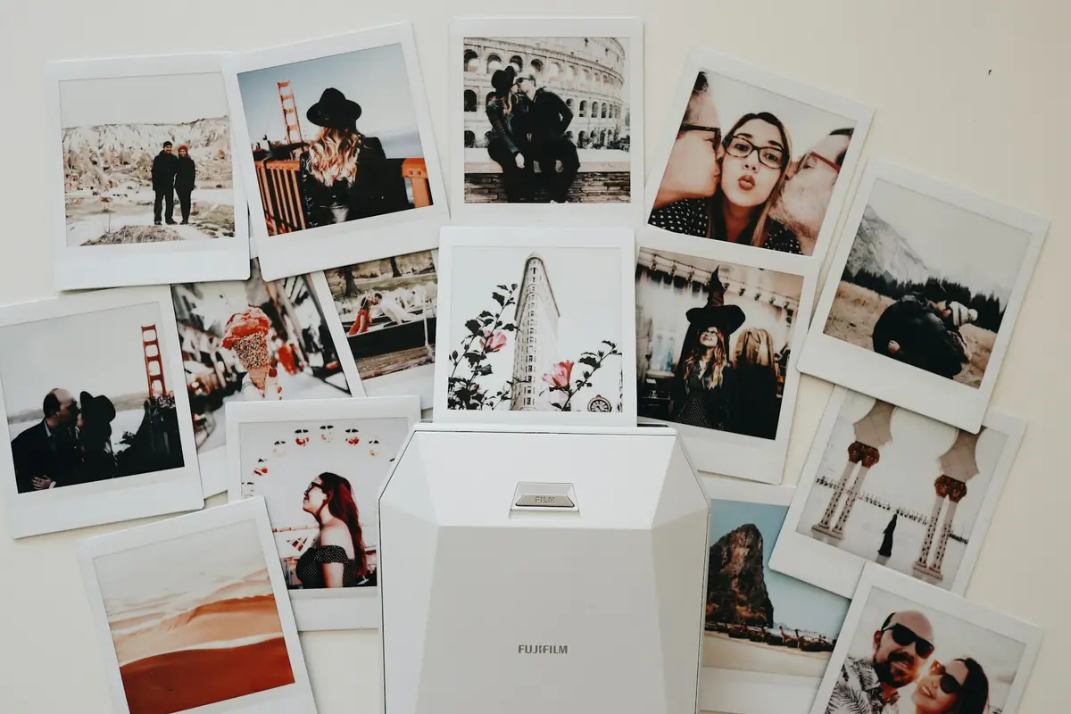 Instant photos pinned to a wall in a collage